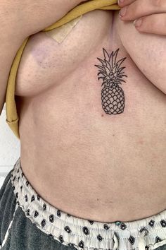 a woman with a pineapple tattoo on her stomach