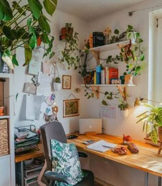 a home office with plants on the wall