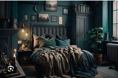 a bedroom with dark green walls and pictures on the wall above the bed, along with candles