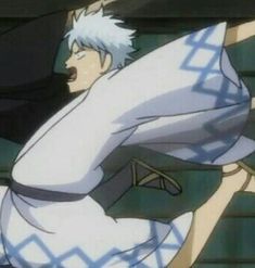 an anime character with white hair is swinging his arm