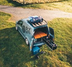 an old car with luggage in the back