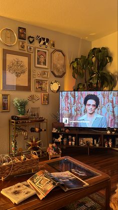 a living room filled with furniture and a flat screen tv sitting on top of a wooden table