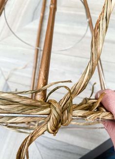 a person is holding some kind of rope in their hand while they are working on something