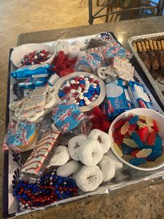 a tray filled with candy and cookies on top of a counter