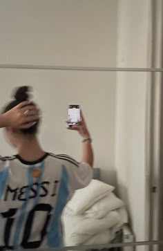 a person taking a selfie in front of a mirror