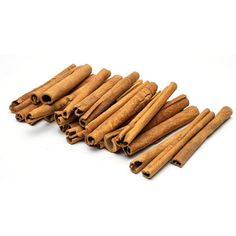 cinnamon sticks are arranged in a row on a white background