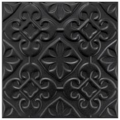 a black tile with an intricate design on it