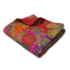 a multicolored blanket is folded on top of each other with an orange and pink patchwork design