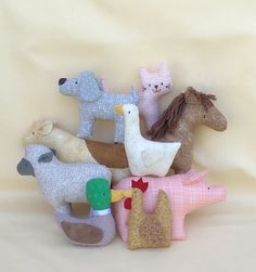 a group of stuffed animals sitting next to each other on a white sheeted surface