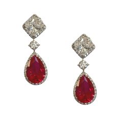 A square princess cut high-grade cubic zirconia simulated diamond is captured within a diamond frame, finished with a suspended large lab-created ruby drop in a halo of diamonds for added movement. Set in 925 silver and polished with rhodium these ruby drop earrings are a  classic timeless treasure to add to your jewellery collection for a statement style that you can afford to indulge in. These are perfect for any special occasion or pair them up with your favourite dress while lunching out with friends or for that romantic or gala event. You know you can expect high quality from Ratnali Jewels and no matter how many sites you check, you will come back to us. If you want good quality, good price and you want to be satisfied with your purchase, Ratnali Jewels are here. Why invest in the re Drop Diamond Earrings, Ruby Drop Earrings, Lorraine Schwartz, Diamond Chandelier Earrings, Silver Diamond Earrings, Turquoise Stud Earrings, Diamond Frame, Daily Jewelry, Opal Earrings Stud