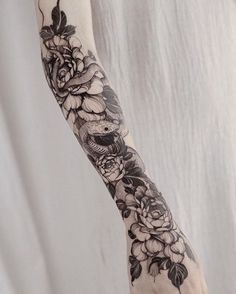 a woman's arm with flowers on it