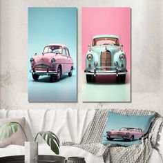 two pink and blue cars in front of each other on a white couch with pillows