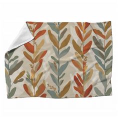 an orange and green leaf print blanket on a white background, with a white border