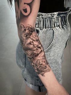 a woman with a lion tattoo on her arm