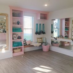 a pink and white room with lots of mirrors