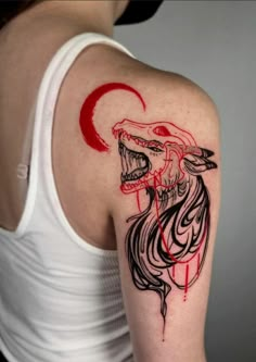 a woman's arm with a tattoo on it that has a red and black design