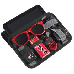 an open case with various items inside it, including sunglasses and other things in it