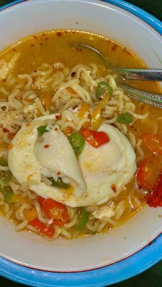 a bowl of soup with noodles, meat and vegetables