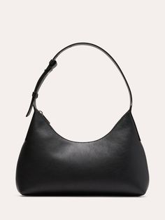 An ode to the 90s minimalist trend, this shoulder bag is cut in a silhouette that hovers somewhere between half-moon and triangle.  Here, we added an adjustable strap and zip closure, keeping the styling sleek to showcase this beautiful leather.  Zip-top closure.  Adjustable shoulder strap.  Height: 7. 7" Width: 11" Depth: 2. 4" Small Black Shoulder Bag, Ford Aesthetic, Elegant Chic Outfits, Euro Winter, Look Expensive On A Budget, How To Look Expensive, Budget Outfits, Wedding Purse, What In My Bag