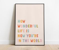 a poster with the words how wonderful life is now you're in the world