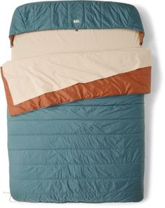 an image of a sleeping bag that is on top of the bed with two pillows