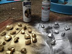 two cans of paint and some rocks on a table