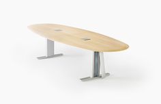 a surfboard shaped table sitting on top of a white floor