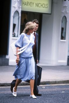 a man and woman walking down the street