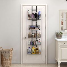 a bathroom with a white door and some shelves on the wall next to a sink