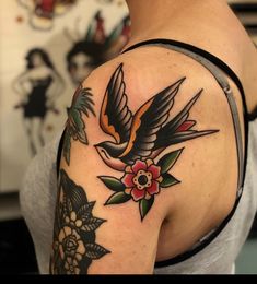 a woman with a bird and flower tattoo on her arm