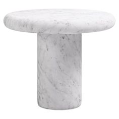 a white marble table with a round base