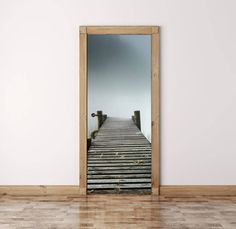 an open door with a reflection of a dock in the mirror, on a wooden floor