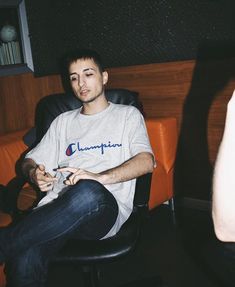 a man sitting in a chair holding a game controller