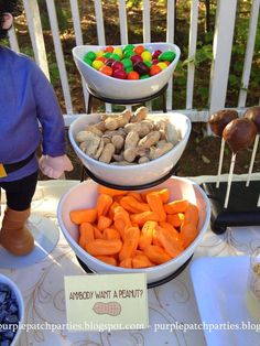 three bowls filled with candy and marshmallows on top of a table