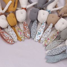 a group of stuffed animals sitting next to each other on top of a white surface