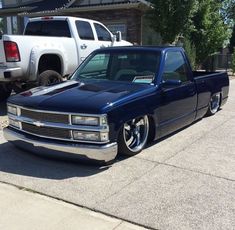 a blue truck parked in front of a house