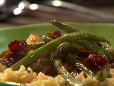 a green plate topped with mashed potatoes covered in cranberry sauce and asparagus