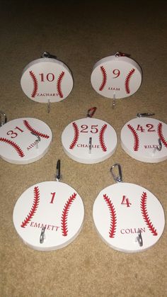 six baseball themed bottle openers on the floor