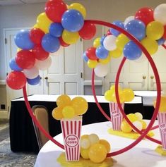 some balloons and popcorn are on the table