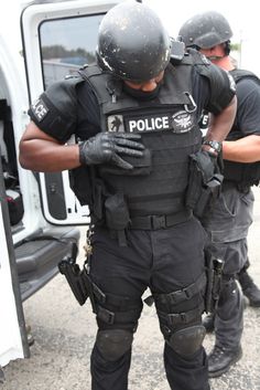 two police officers are standing in front of a van