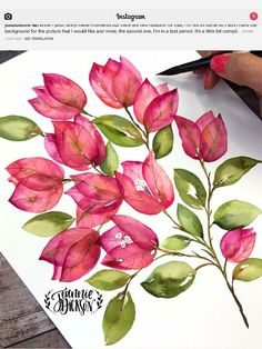 someone is drawing flowers with watercolors on paper