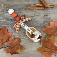 an assortment of fall leaves and treats on a wooden table with the words maple syrup