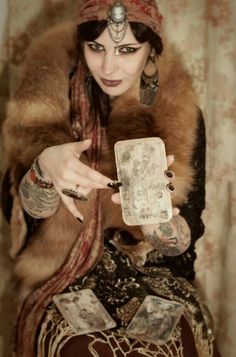 a woman in a fur coat holding a card