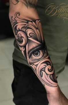 a man with an eye tattoo on his arm