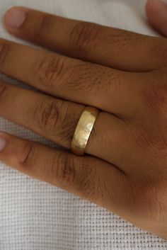 This comfort fit hammered gold wedding band features a rugged yet refined design, showcasing a textured surface that reflects light from every angle. Custom made to order. Please allow 2-3 weeks for delivery. Hammered Gold Wedding Band, Hammered Band, Hammered Gold, New Bands, Gold Wedding Band, Ring Collections, Diamond Studs, 18k Rose Gold, Gold Wedding