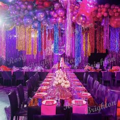 a long table with purple and pink decorations