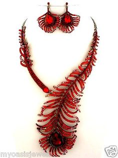 a necklace and earring set with red beads