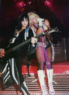 two women with guitars on stage at a concert