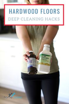 a woman holding two bottles of cleaning hacks with the words, hardwood floors deep cleaning hacks