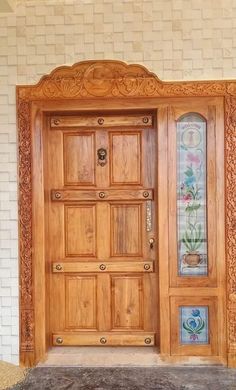 a wooden door with decorative glass panels on it